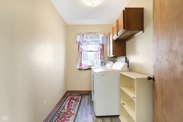 clothes washing area with separate washer and dryer, cabinets, and dark hardwood / wood-style floors