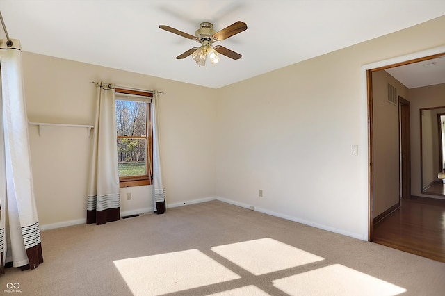 interior space featuring light carpet and ceiling fan