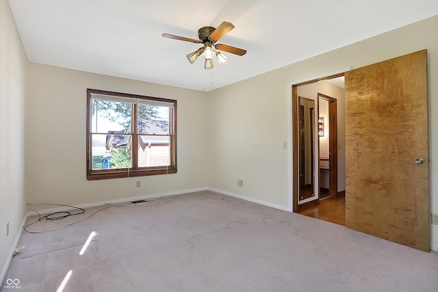 carpeted empty room with ceiling fan