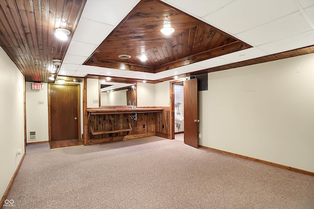 basement featuring wooden ceiling and light colored carpet