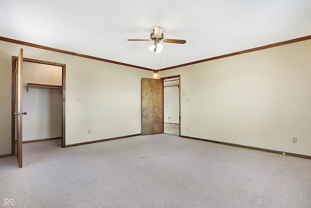 unfurnished bedroom featuring a closet, light carpet, ceiling fan, and crown molding