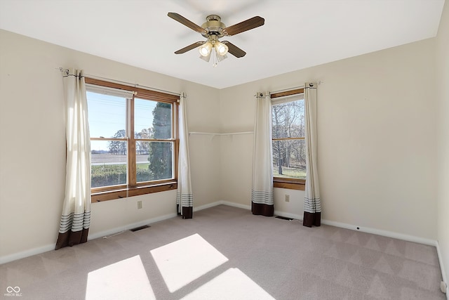 empty room with light colored carpet and ceiling fan