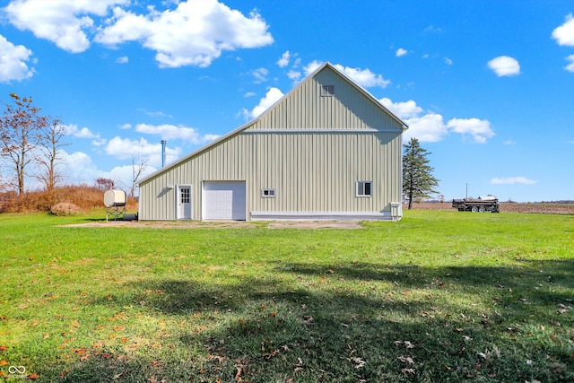 view of outdoor structure with a garage and a lawn