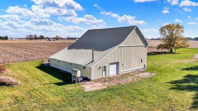 view of outdoor structure with a yard and a rural view