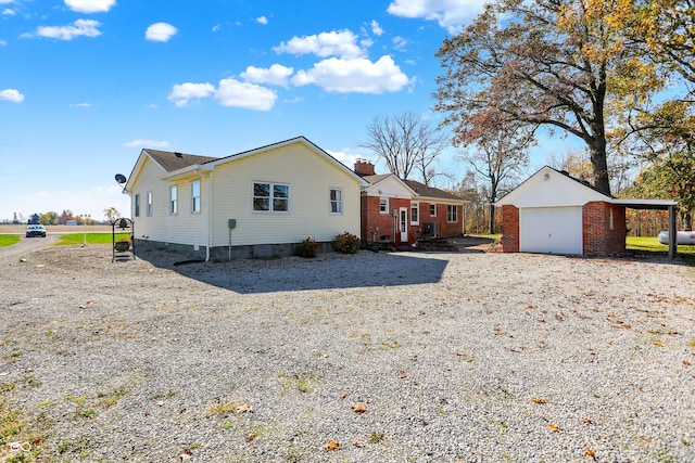 view of property exterior featuring a garage and an outdoor structure