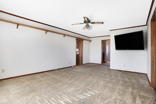 unfurnished living room with light colored carpet, ceiling fan, and crown molding