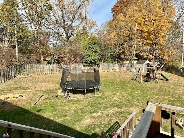 view of yard with a trampoline and a playground