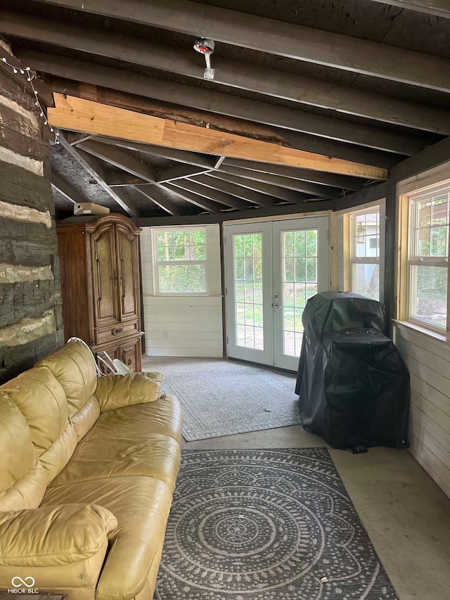 living room featuring french doors, a healthy amount of sunlight, and lofted ceiling with beams