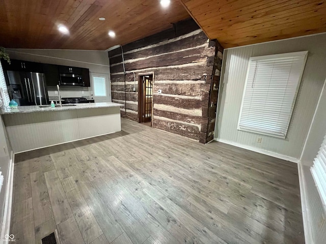 bar featuring wood ceiling, dark wood-type flooring, sink, vaulted ceiling, and appliances with stainless steel finishes