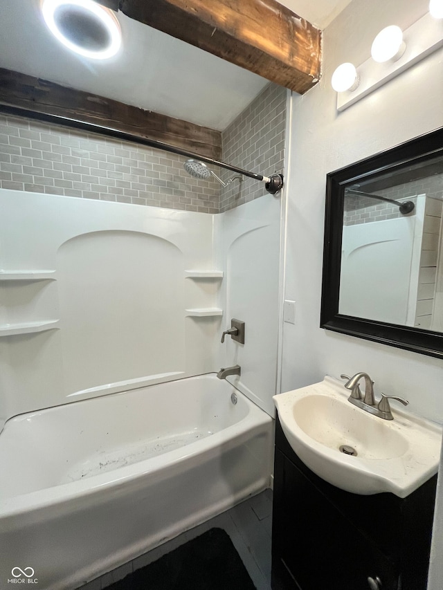 bathroom featuring vanity, tiled shower / bath combo, and tile patterned flooring