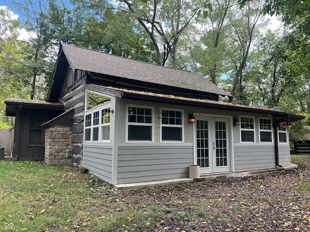 exterior space featuring central AC and a lawn