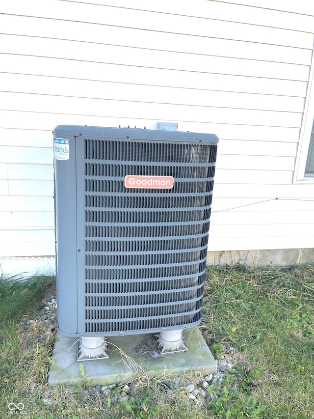 exterior details with wood walls and central AC unit