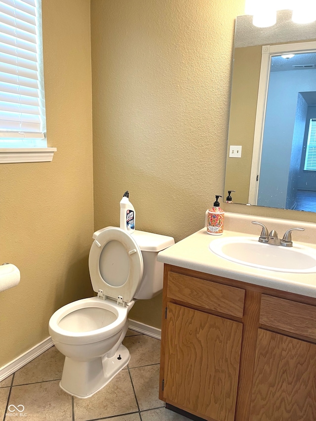 bathroom featuring vanity, toilet, and tile patterned floors