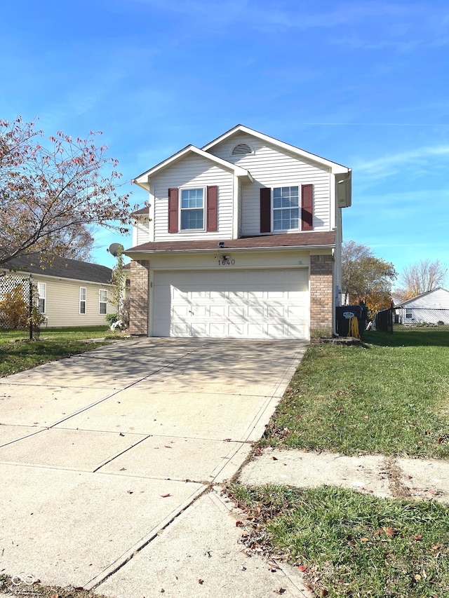 front of property featuring a front yard and a garage