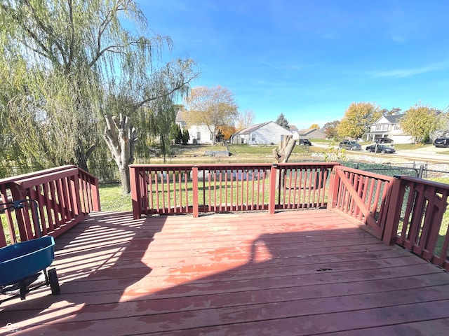 wooden deck with a lawn