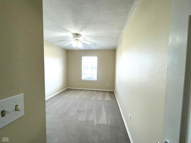 carpeted empty room featuring a textured ceiling and ceiling fan