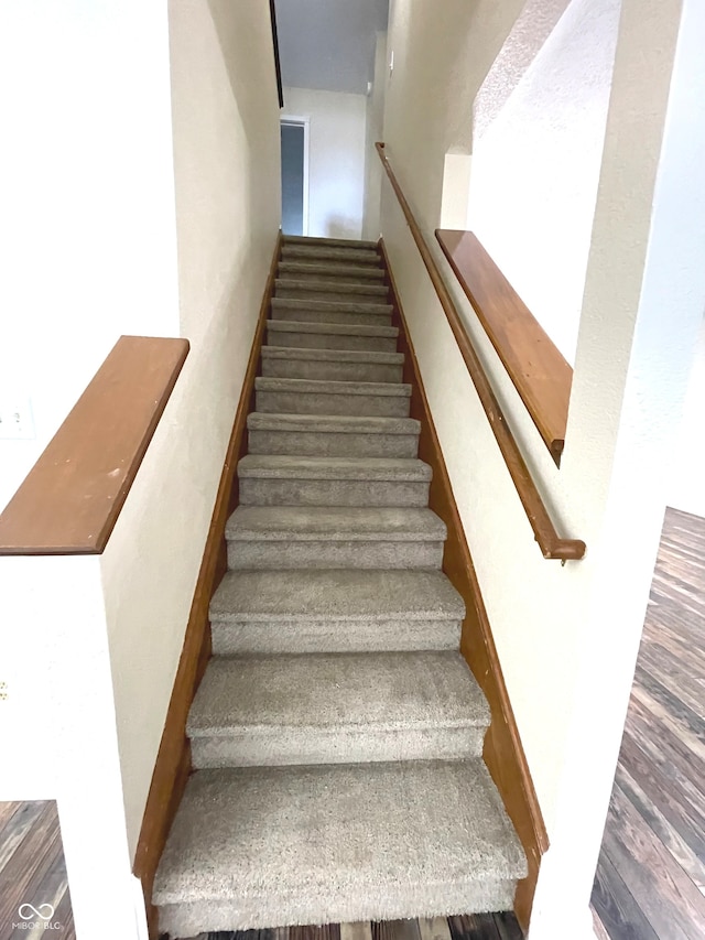 stairs with wood-type flooring