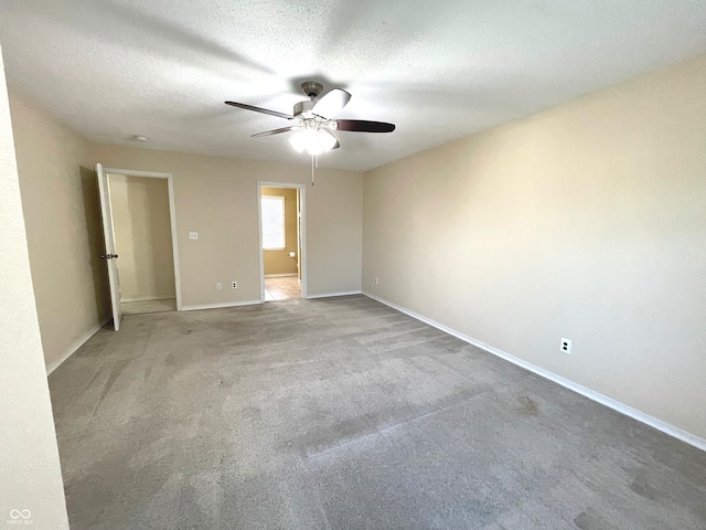 empty room with light carpet, a textured ceiling, and ceiling fan