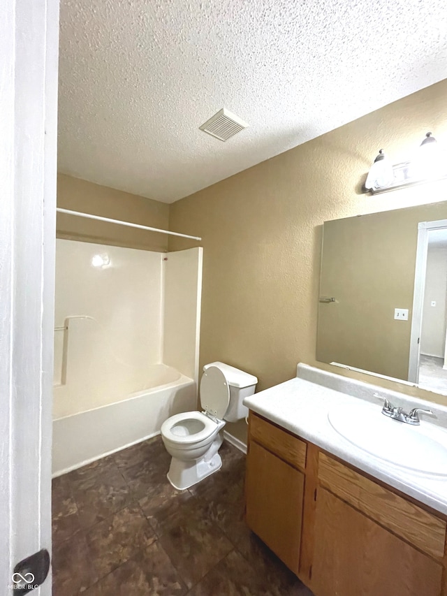 full bathroom with vanity, toilet, bathtub / shower combination, and a textured ceiling