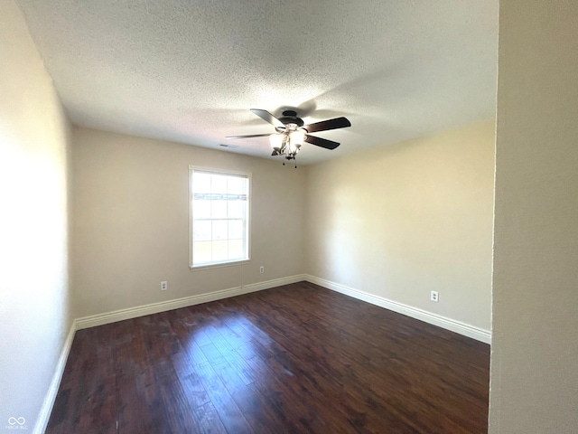 unfurnished room with ceiling fan, a textured ceiling, and dark hardwood / wood-style flooring