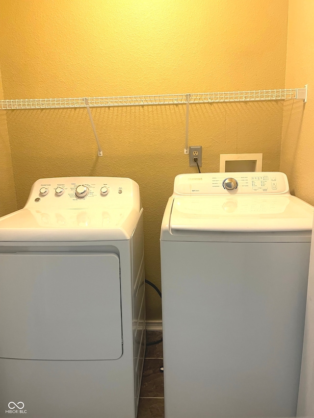 laundry area with washing machine and dryer and tile patterned flooring