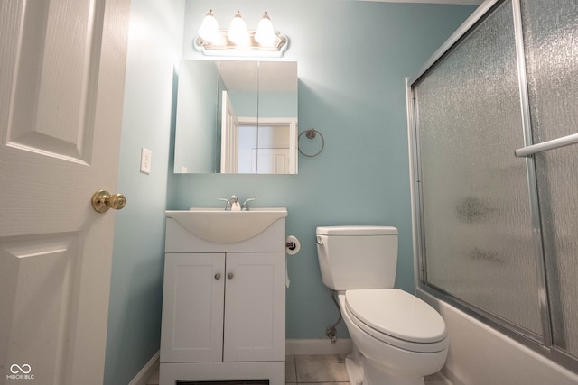 full bathroom with bath / shower combo with glass door, tile patterned floors, vanity, and toilet