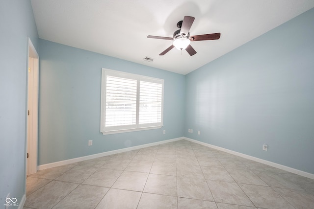 tiled spare room featuring ceiling fan and vaulted ceiling