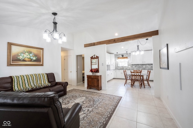 living room featuring beamed ceiling, light tile patterned floors, and an inviting chandelier