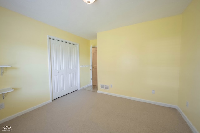 unfurnished bedroom with a closet and carpet floors