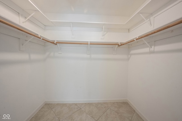 spacious closet featuring light tile patterned floors