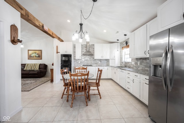 kitchen featuring white cabinets, lofted ceiling with beams, and appliances with stainless steel finishes