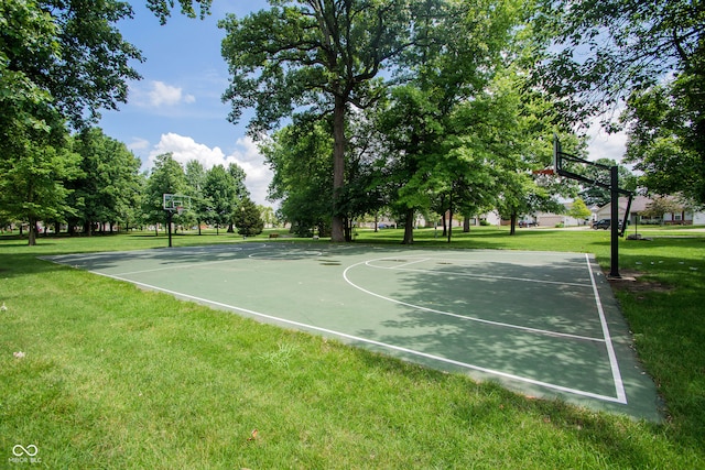 view of sport court featuring a lawn