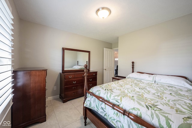 tiled bedroom with a textured ceiling