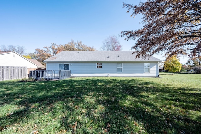 rear view of property featuring a lawn