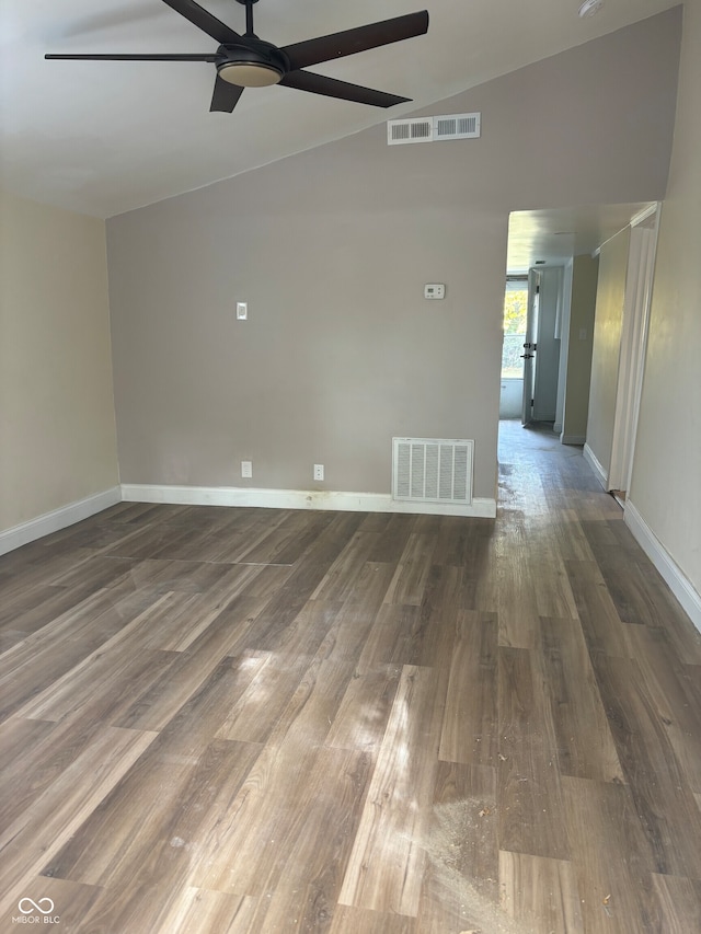 empty room featuring vaulted ceiling, ceiling fan, and dark hardwood / wood-style flooring