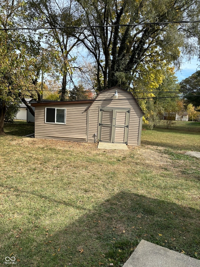 view of outdoor structure featuring a lawn