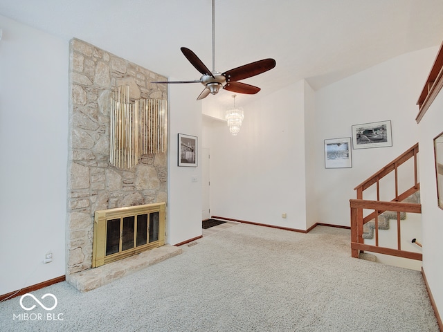 unfurnished living room with light carpet, heating unit, ceiling fan, a fireplace, and a high ceiling