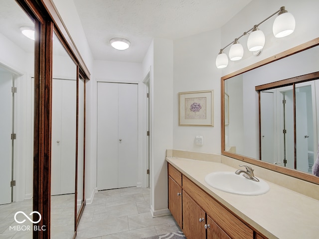 bathroom featuring vanity and a textured ceiling