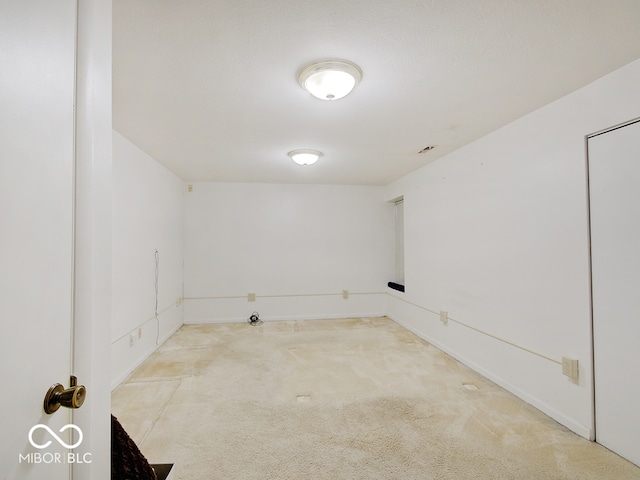 laundry room featuring light colored carpet