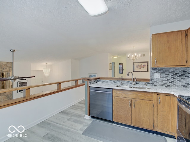 kitchen featuring light hardwood / wood-style floors, sink, hanging light fixtures, dishwasher, and electric range