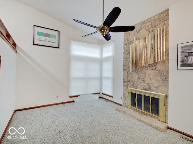 unfurnished living room featuring a fireplace, ceiling fan, and carpet floors