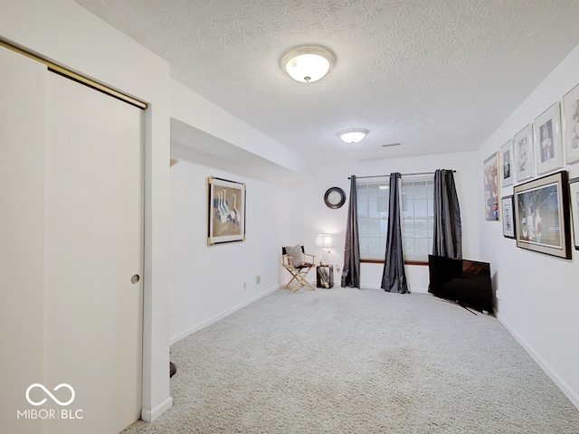 bedroom featuring a textured ceiling and carpet flooring