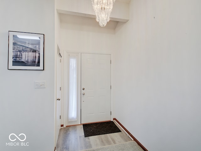 entryway featuring an inviting chandelier and hardwood / wood-style flooring