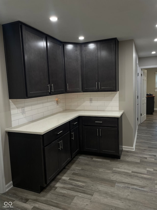 kitchen featuring tasteful backsplash and light hardwood / wood-style flooring