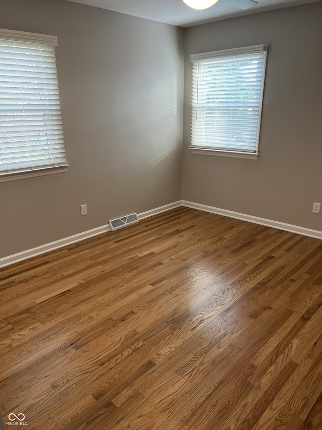 spare room with wood-type flooring