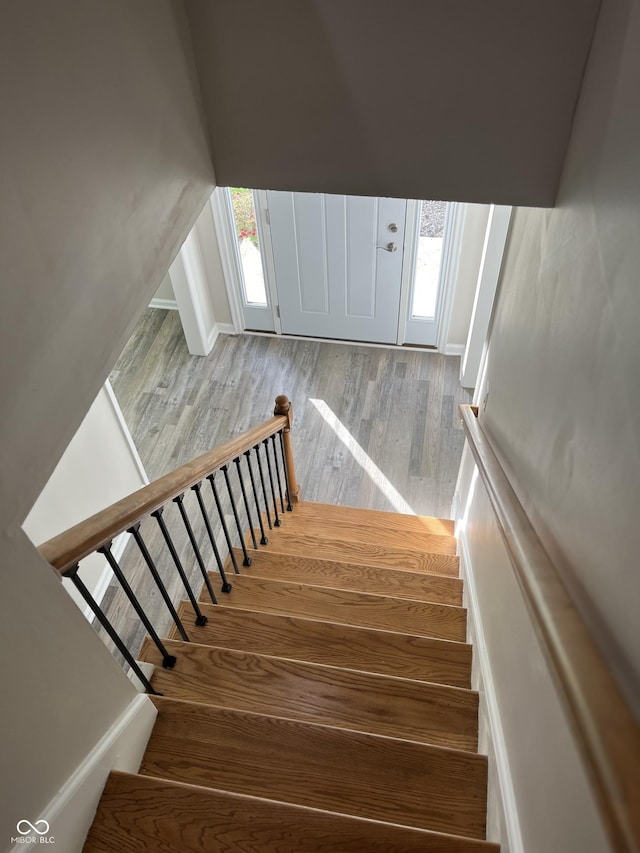 stairway featuring hardwood / wood-style floors