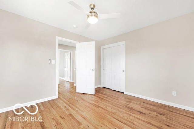 spare room with light wood-style floors, baseboards, and a ceiling fan