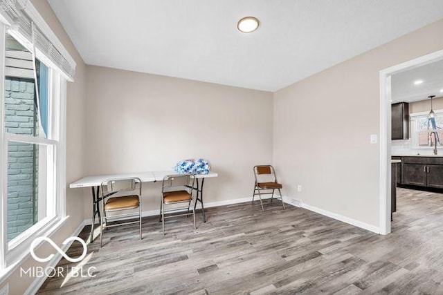 sitting room with baseboards and wood finished floors