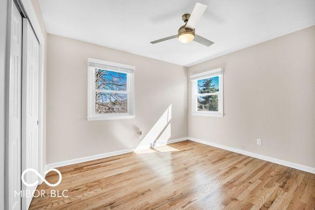 unfurnished bedroom with a ceiling fan, baseboards, a closet, and wood finished floors