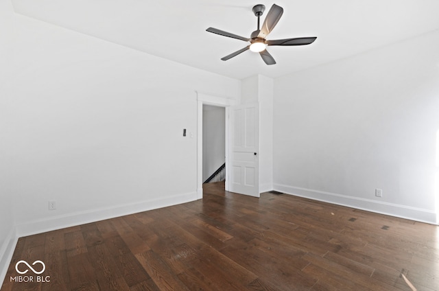 empty room featuring ceiling fan and dark hardwood / wood-style flooring